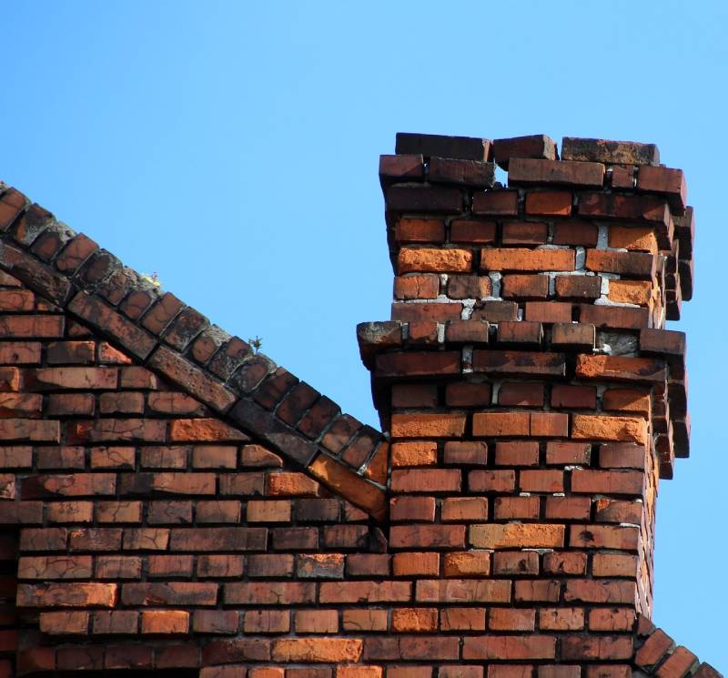 Damaged chimney on an Forest Park home showing cracks and missing mortar